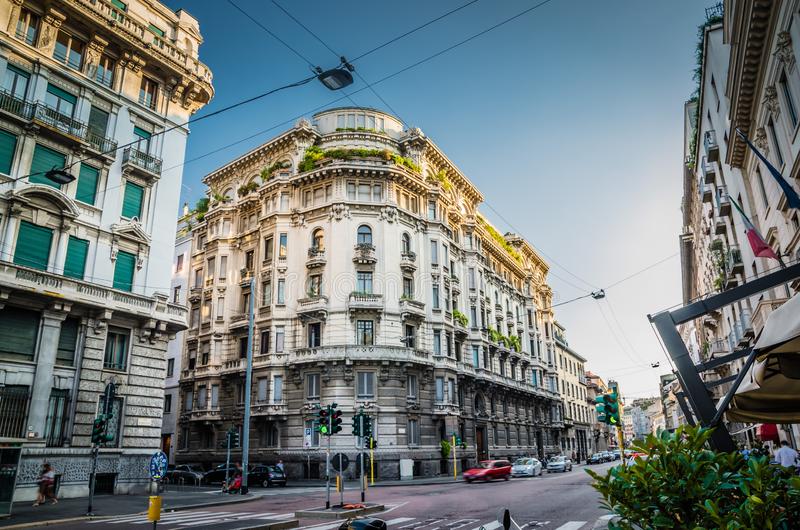 old-typical-building-balconies-centre-milan-italy-corner-windows-moulding-stucco-work-greenery-roof-main-street-132524912